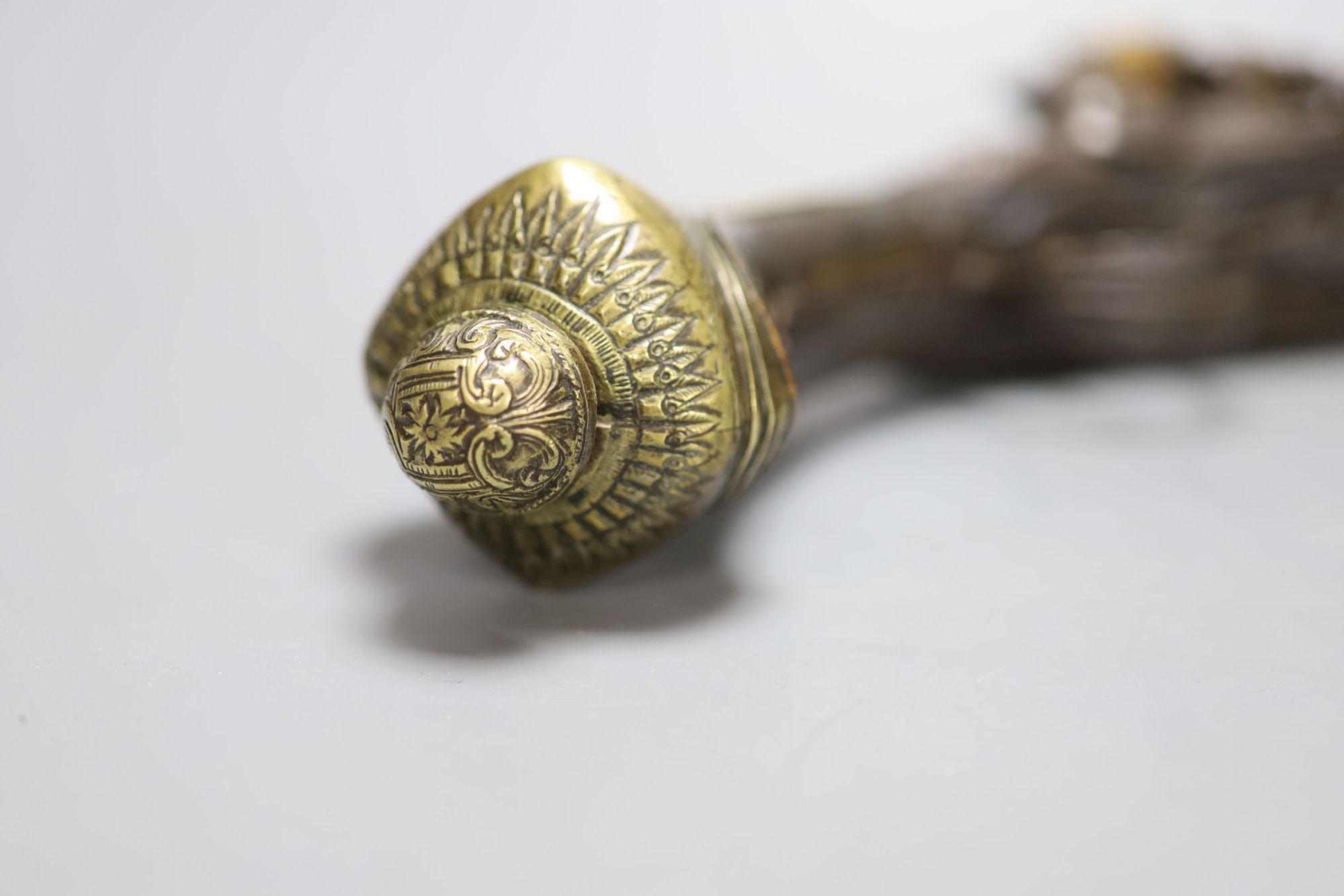 A 19th century Ottoman carved wood and brass mounted flintlock pistol, length 45cm